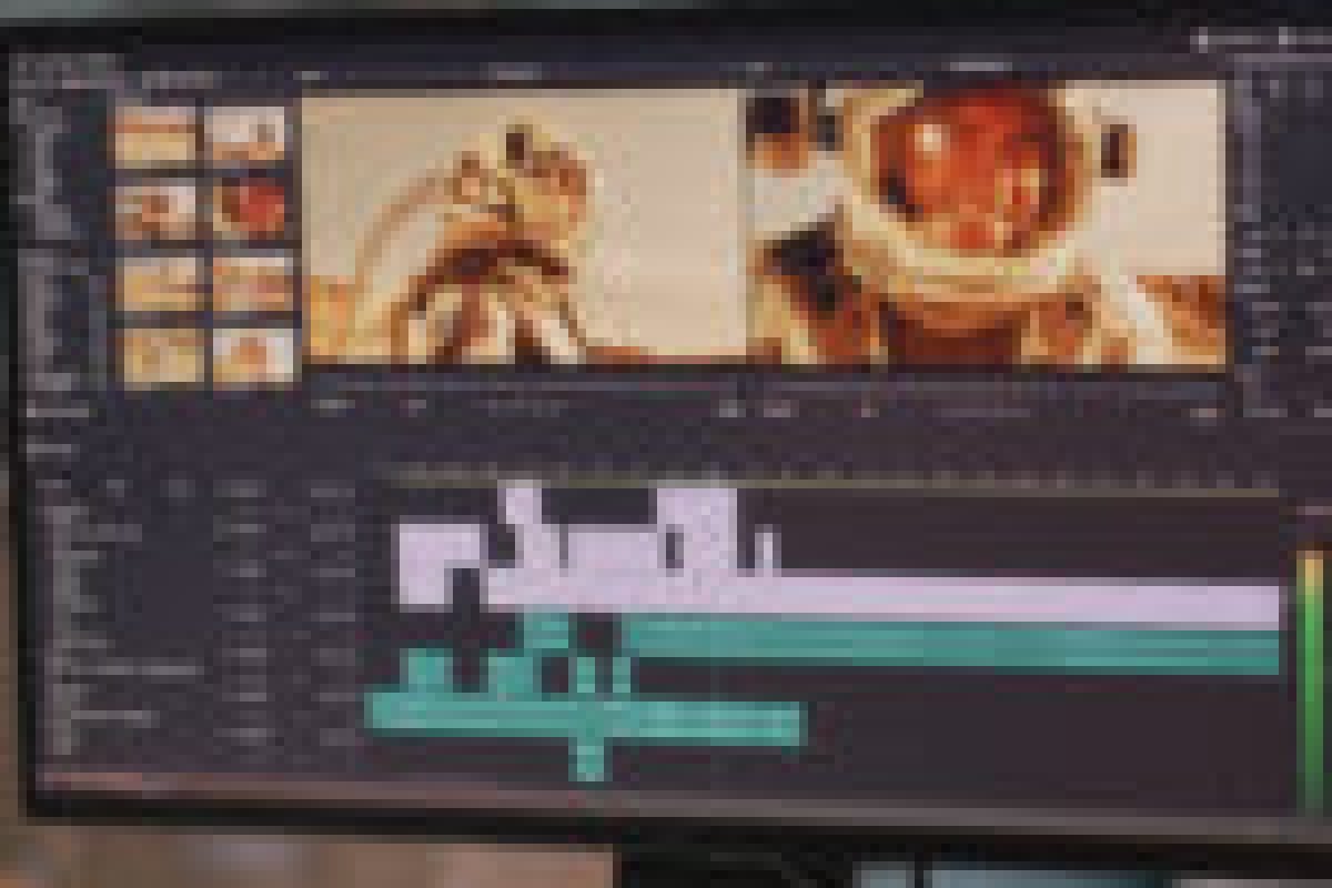 Back view of male content creator using computer to edit cosmonaut video during remote work from home